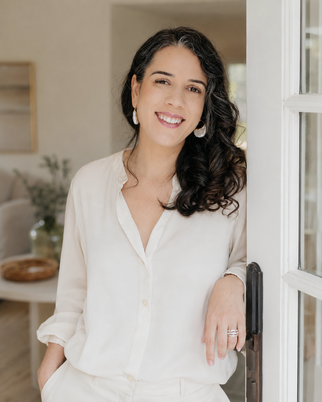 Paula Miles, psychotherapist, smiling in a doorway